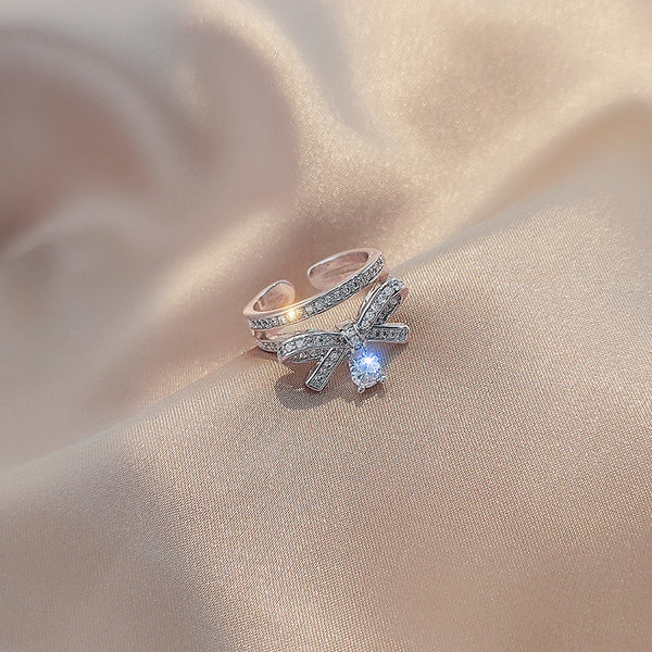 Bow-design ring with gemstones