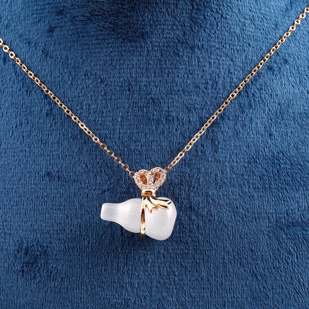 Gold Necklace with Frosted White Bottle Pendant and Bow Accent