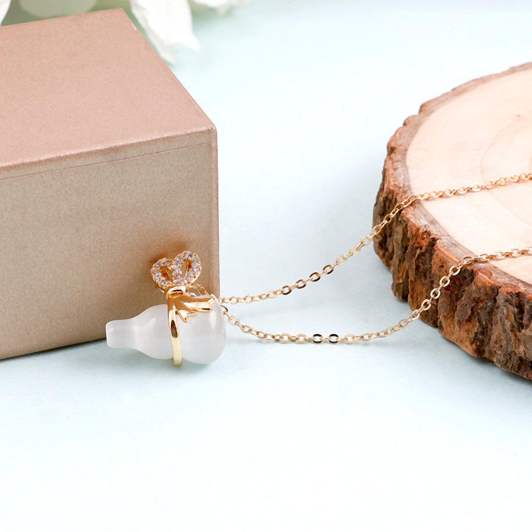 Gold Necklace with Frosted White Bottle Pendant and Bow Accent