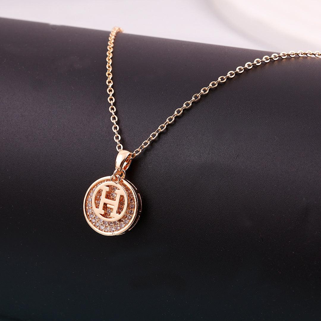 Gold Necklace with Circular Pendant and 'H' Initial Design