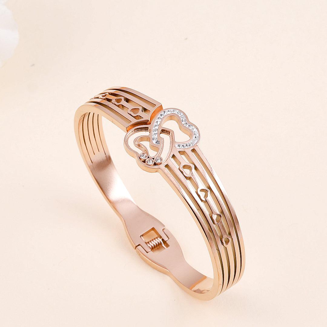 Rose Gold Plated Bracelet with Interlocking Heart Design and Crystal Accents".