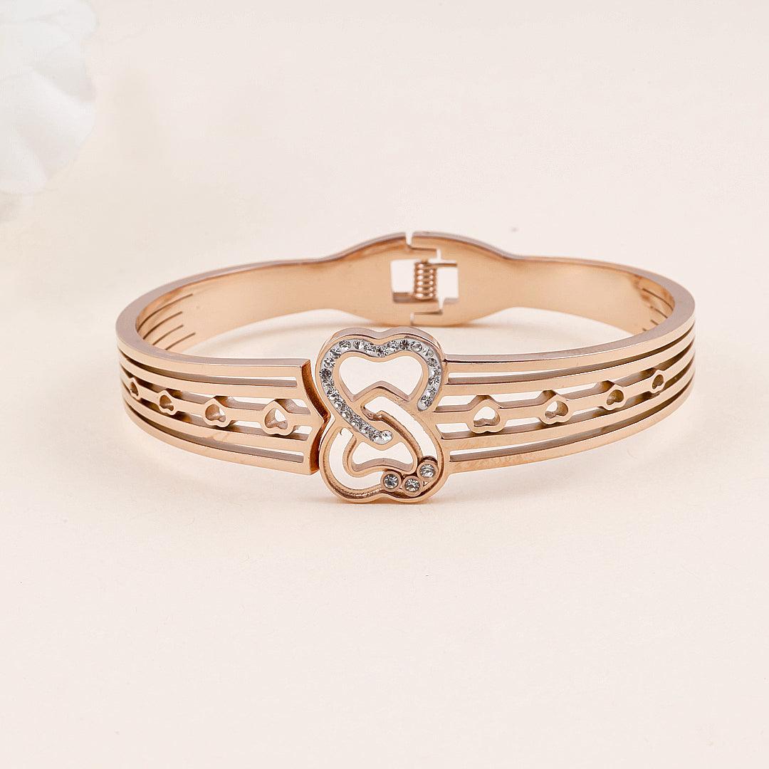 Rose Gold Plated Bracelet with Interlocking Heart Design and Crystal Accents".